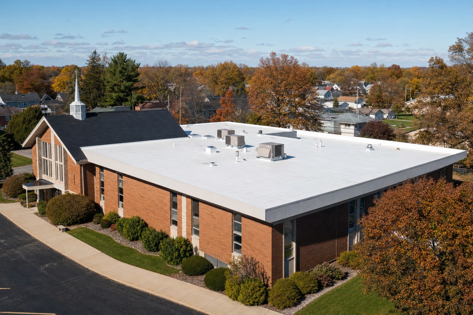 Brick church with a low-slope commercial roof
