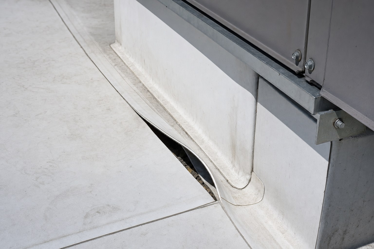 Open roof seam beside rooftop unit curb